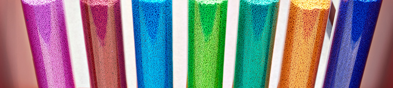 mehrere Gläser mit bunten Kunststoffgranulat